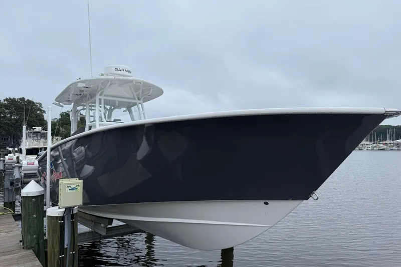 Slide: The Image of 2022 Cape Horn 34 XS boat docked at marina, overcast sky. - 8
