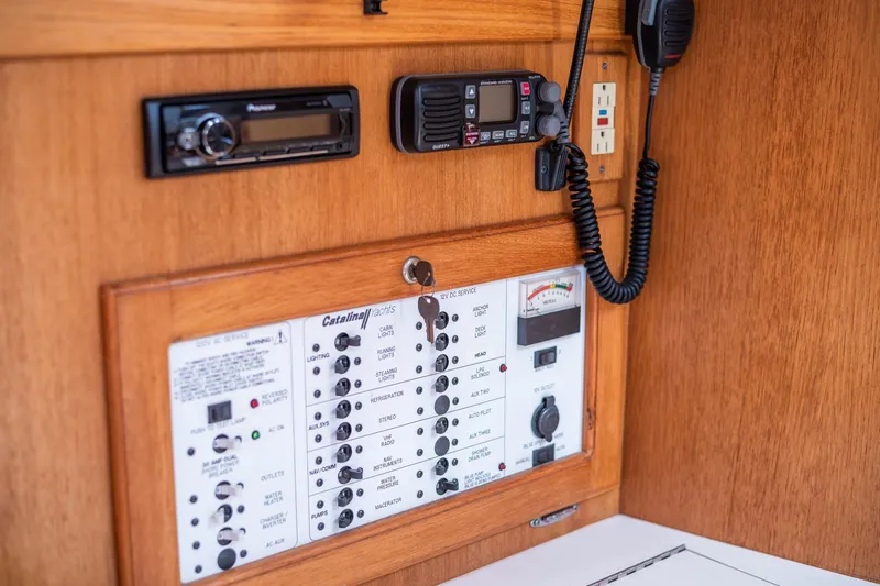 Slide: The Image of Control panel of a 2005 Catalina 36 MkII yacht with radio and electrical switches. - 11