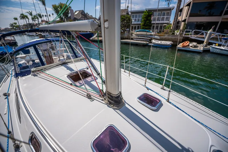 Slide: The Image of 2005 Catalina 36 MkII sailboat docked in a sunny marina, showcasing deck and rigging. - 16