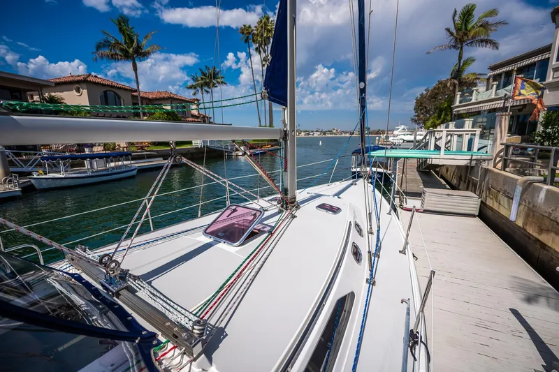 Slide: The Image of Catalina 36 MkII 2005 sailboat docked in a sunny marina with palm trees. - 17