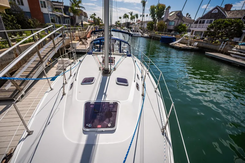 Slide: The Image of 2005 Catalina 36 MkII sailboat docked in a scenic residential canal. - 18