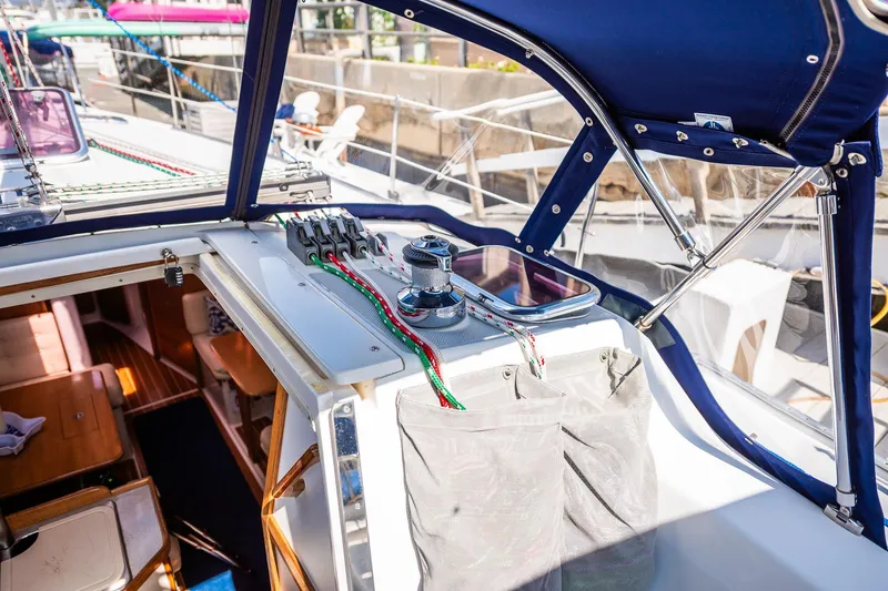 Slide: The Image of 2005 Catalina 36 MkII sailboat cockpit with winch and colorful ropes under blue canopy. - 19