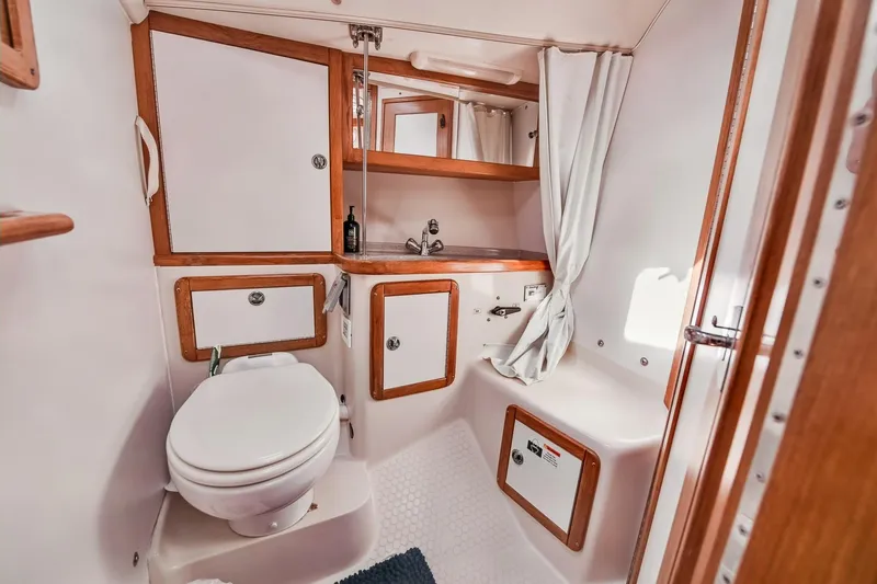 Slide: The Image of 2005 Catalina 36 MkII yacht bathroom with wooden accents and compact design. - 22
