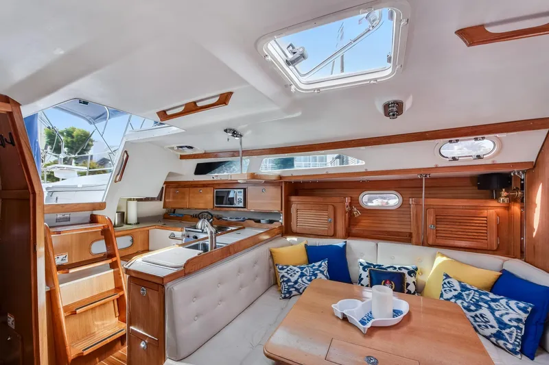 Slide: The Image of Interior of 2005 Catalina 36 MkII sailboat with cozy seating and wooden cabinetry. - 24