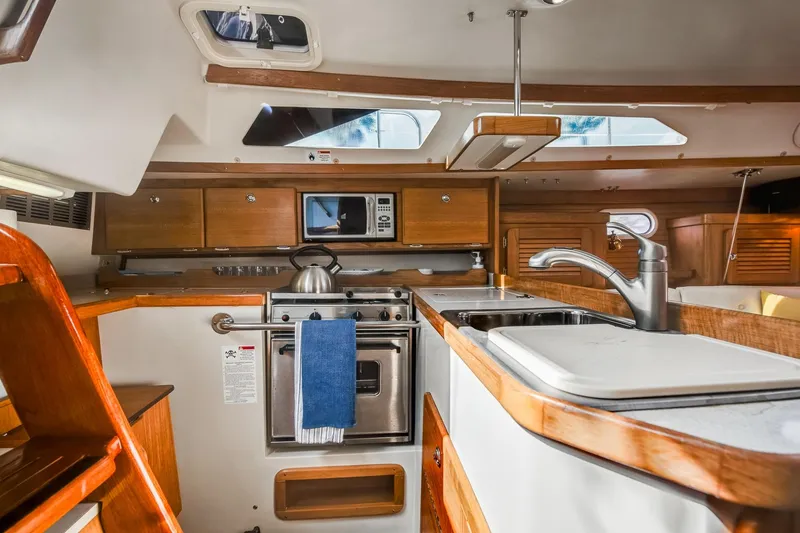 Slide: The Image of Interior of 2005 Catalina 36 MkII yacht kitchen with stove, sink, and microwave. - 25