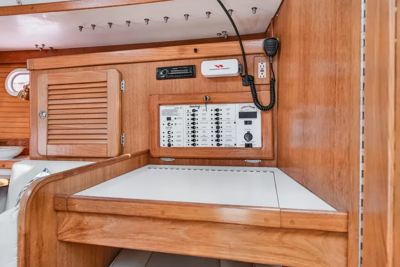 Slide: The Image of 2005 Catalina 36 MkII interior with control panel and wooden cabinetry. - 30