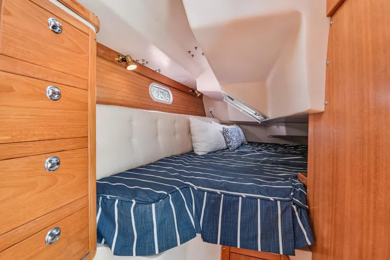 Slide: The Image of Cozy cabin interior of 2005 Catalina 36 MkII sailboat with striped bedding. - 31