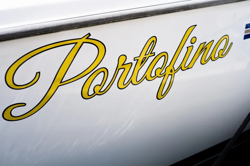 Slide: The Image of Yellow "Portofino" lettering on 2005 Catalina 36 MkII sailboat hull. - 5