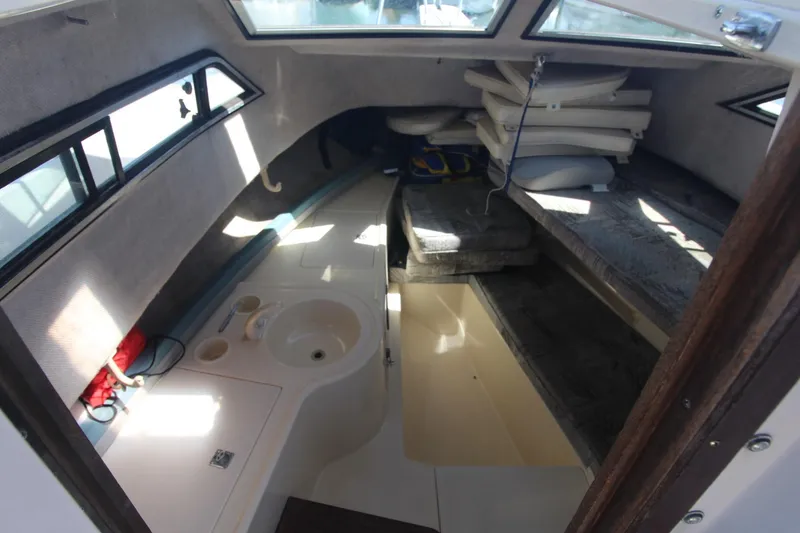 Slide: The Image of 1992 Grady-White Gulfstream 232 cabin interior with seating and storage. - 12