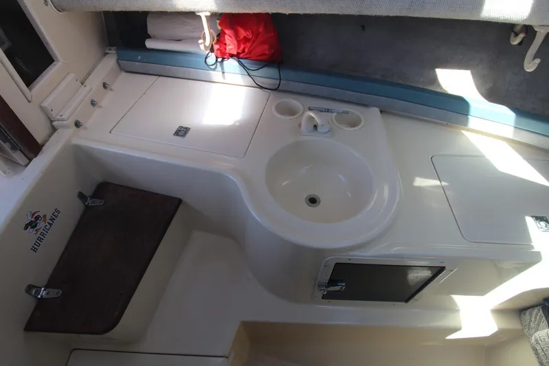 Slide: The Image of Interior of 1992 Grady-White Gulfstream 232 boat with sink and storage compartments. - 14