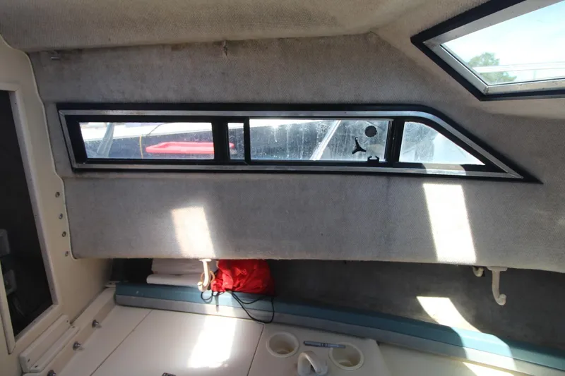 Slide: The Image of Interior cabin view of 1992 Grady-White Gulfstream 232 boat with window and storage area. - 15