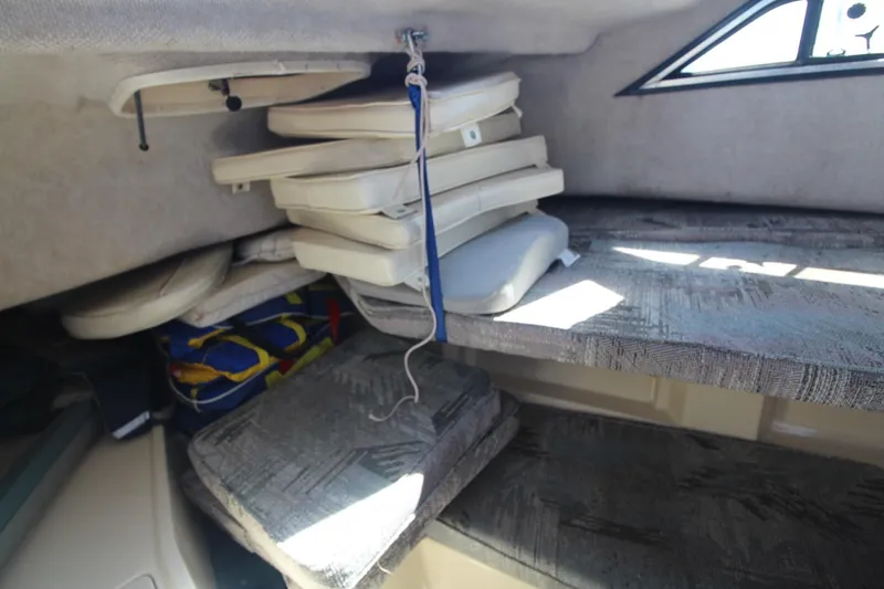 Slide: The Image of Interior cabin of 1992 Grady-White Gulfstream 232 with stacked cushions and window. - 19