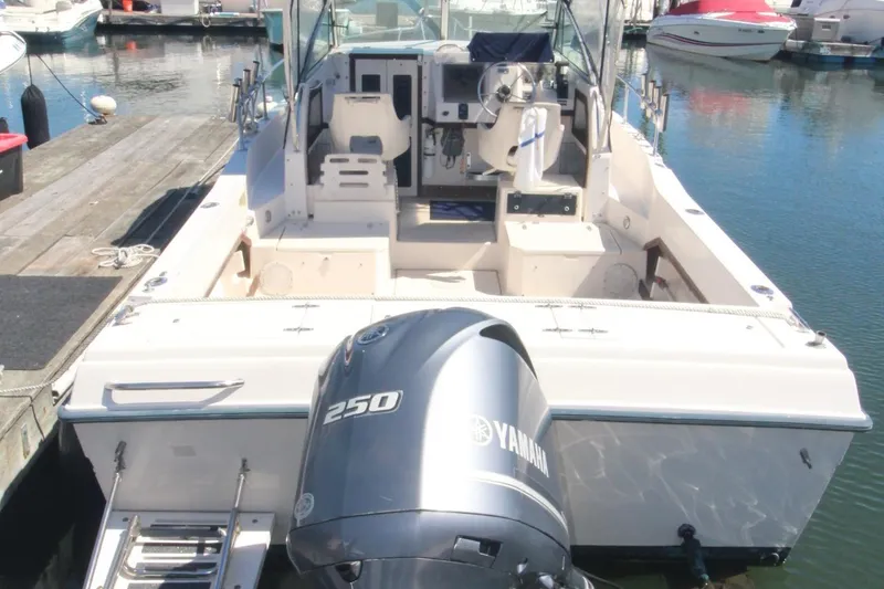 Slide: The Image of 1992 Grady-White Gulfstream 232 boat with Yamaha 250 engine docked at marina. - 2