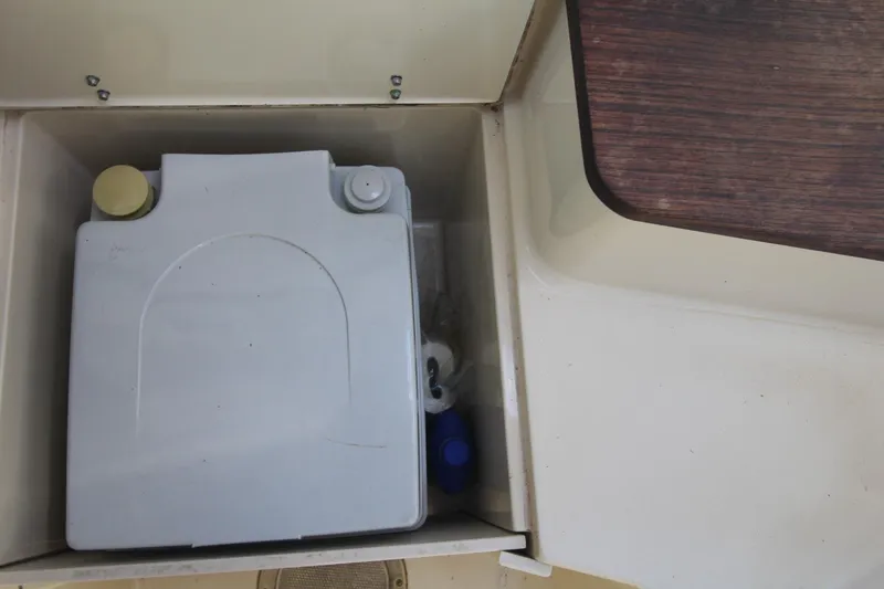 Slide: The Image of Storage compartment on 1992 Grady-White Gulfstream 232 boat with a portable container. - 20