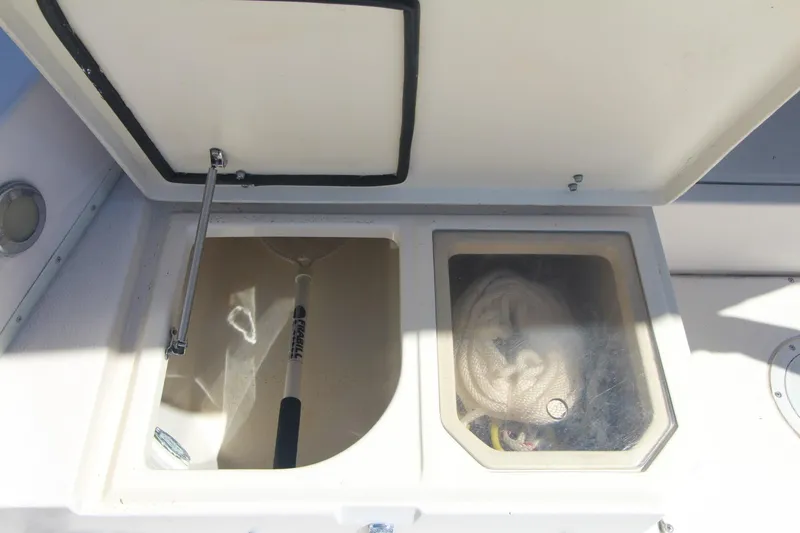 Slide: The Image of Storage compartments on a 1992 Grady-White Gulfstream 232 boat, featuring a rope and handle. - 22