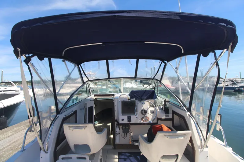 Slide: The Image of 1992 Grady-White Gulfstream 232 boat interior with canopy, docked at marina. - 23