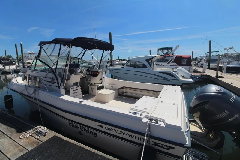 Slide: The Image of 1992 Grady-White Gulfstream 232 boat docked at marina under clear blue sky. - 3