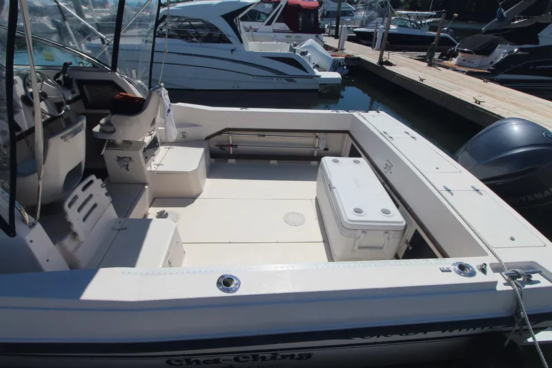 Slide: The Image of 1992 Grady-White Gulfstream 232 boat interior at marina, featuring spacious deck and seating. - 7