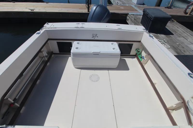 Slide: The Image of 1992 Grady-White Gulfstream 232 boat deck with cooler, docked at marina. - 8