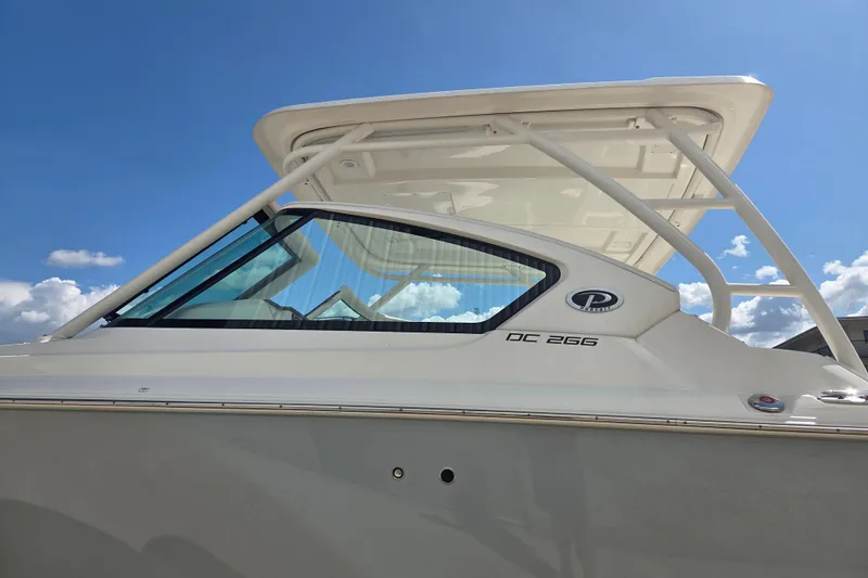 Slide: The Image of 2023 Pursuit DC 266 Dual Console boat under clear blue sky. - 1