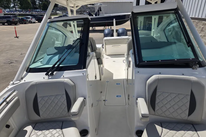 Slide: The Image of 2023 Pursuit DC 266 Dual Console boat interior with seating and windshield view. - 12