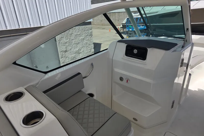 Slide: The Image of 2023 Pursuit DC 266 Dual Console interior with seating and storage compartments. - 13