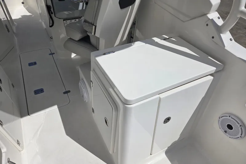 Slide: The Image of 2023 Pursuit DC 266 Dual Console interior with seating and storage compartments. - 19