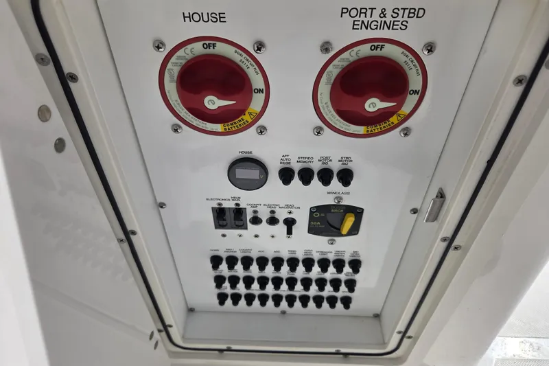 Slide: The Image of Control panel of 2023 Pursuit DC 266 Dual Console boat with switches and dials. - 21