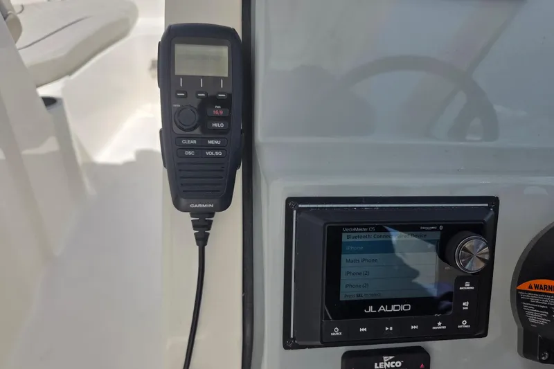 Slide: The Image of Garmin radio and JL Audio system on 2023 Pursuit DC 266 Dual Console boat. - 23
