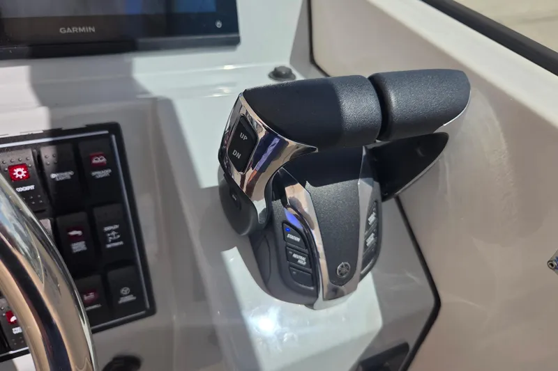 Slide: The Image of Close-up of 2023 Pursuit DC 266 Dual Console boat controls and Garmin display. - 24