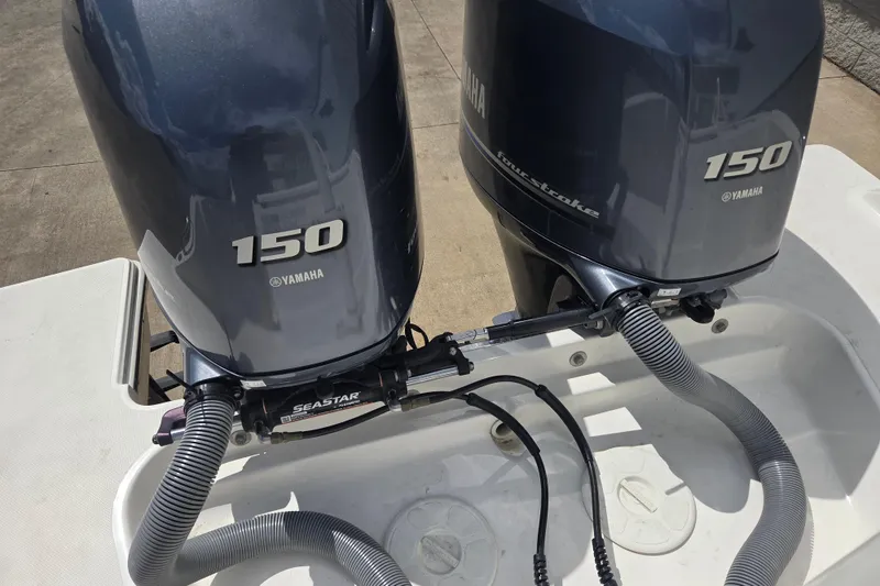 Slide: The Image of Twin Yamaha 150 outboard engines on a 2023 Pursuit DC 266 Dual Console boat. - 28