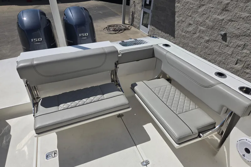 Slide: The Image of 2023 Pursuit DC 266 Dual Console boat with gray seating and twin Yamaha 150 engines. - 5