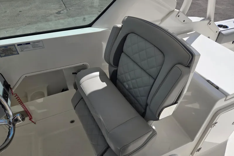 Slide: The Image of 2023 Pursuit DC 266 Dual Console boat seat with quilted upholstery. - 9