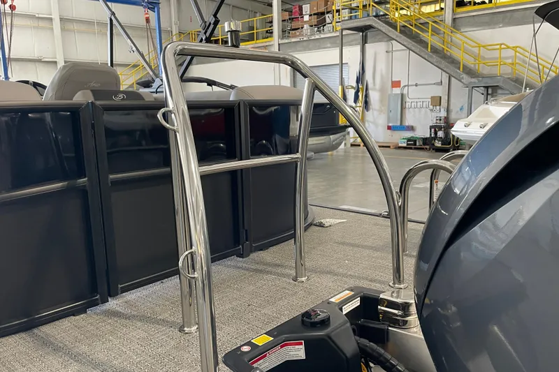 Slide: The Image of 2026 Barletta ARIA 22QC pontoon boat interior with stainless steel railings in a warehouse. - 10