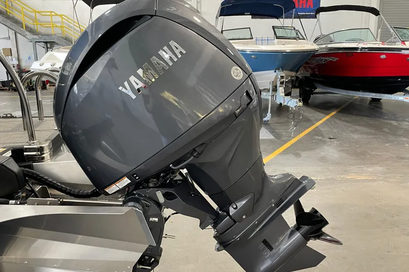 Slide: The Image of 2026 Barletta ARIA 22QC with Yamaha outboard motor in a showroom. - 12