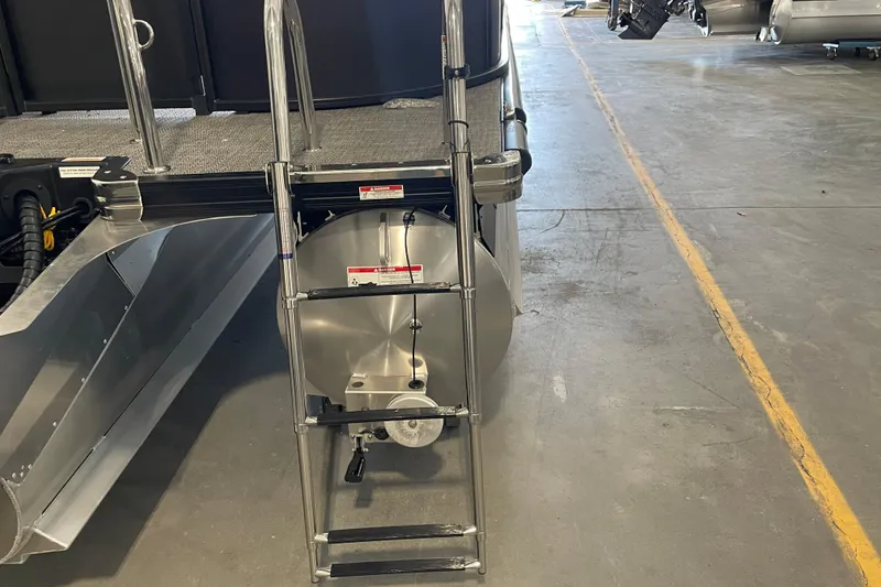 Slide: The Image of 2026 Barletta ARIA 22QC pontoon boat ladder and rear view in a warehouse. - 15