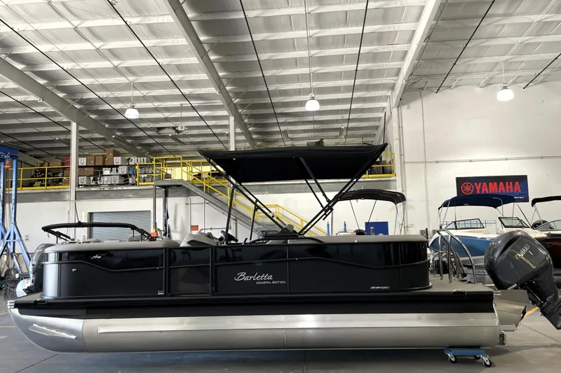 Slide: The Image of 2026 Barletta ARIA 22QC pontoon boat in a showroom with Yamaha signage. - 3