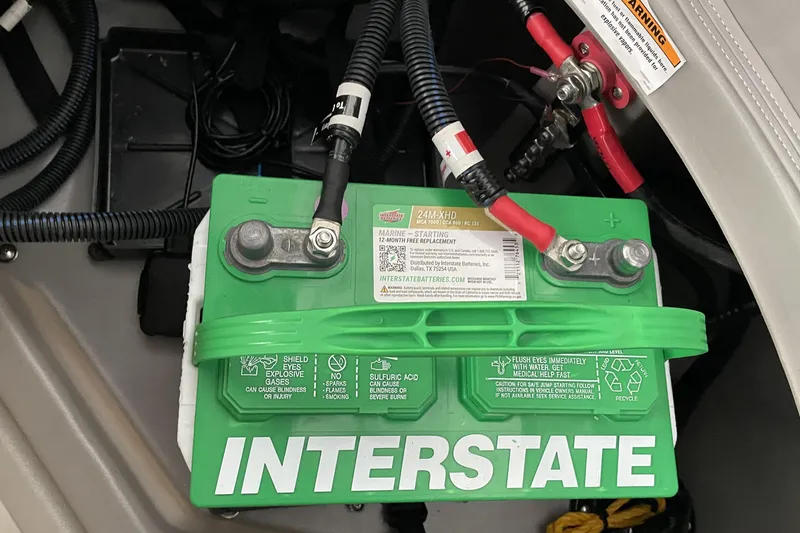 Slide: The Image of Interstate battery in Barletta ARIA 22QC 2026 model, showing connections and safety labels. - 37