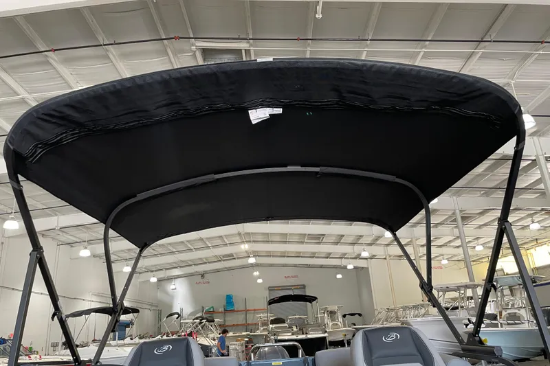 Slide: The Image of 2026 Barletta ARIA 22QC boat with black canopy in a showroom. - 38