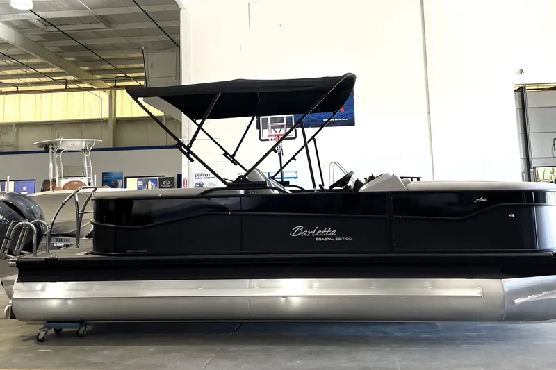 Slide: The Image of 2026 Barletta ARIA 22QC pontoon boat with canopy in showroom setting. - 4