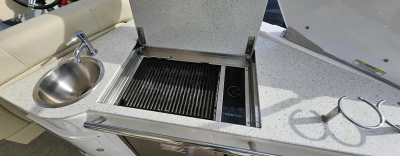 Slide: The Image of Outdoor kitchen on 2018 Regal 33 XO boat with grill and sink. - 10
