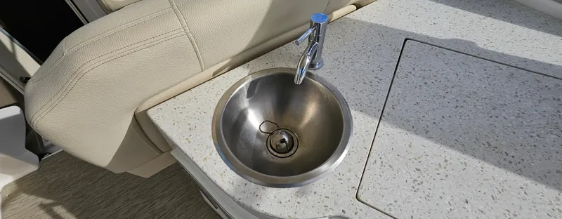 Slide: The Image of Stainless steel sink on 2018 Regal 33 XO boat with speckled countertop. - 11