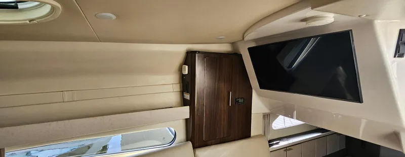 Slide: The Image of Interior of 2018 Regal 33 XO yacht with TV and wooden cabinet. - 15