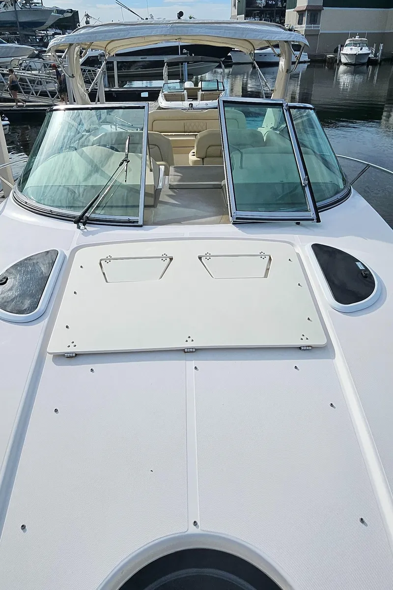 Slide: The Image of 2018 Regal 33 XO boat with open deck and glass windshield at marina. - 34