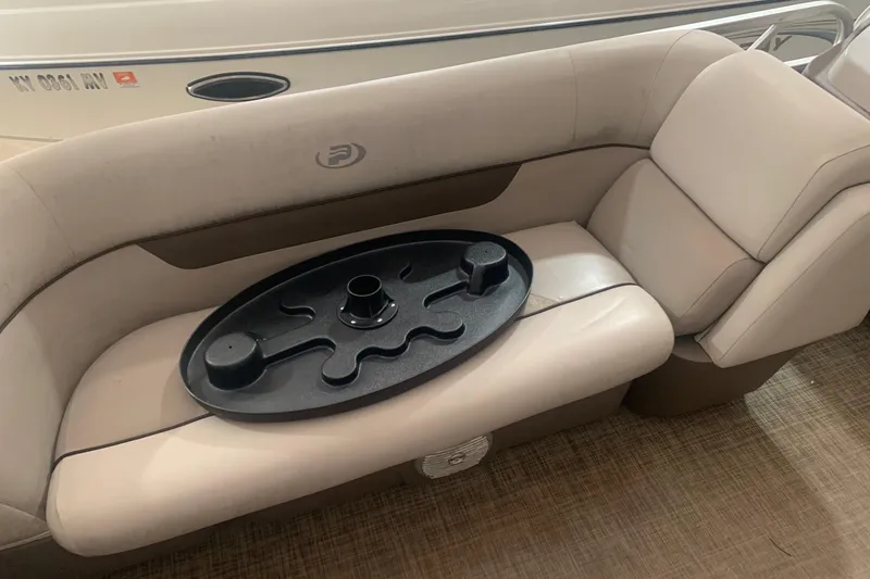 Slide: The Image of 2018 Princecraft Vectra 23 XT boat interior with beige seating and black table attachment. - 16