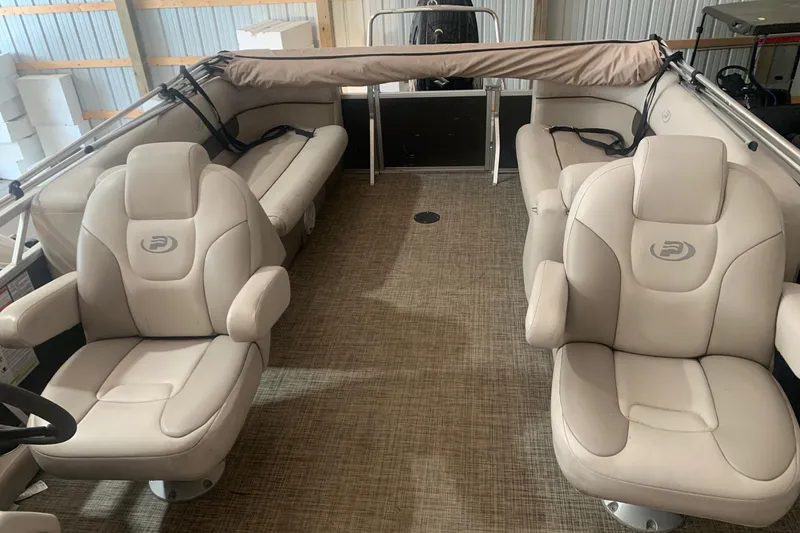 Slide: The Image of 2018 Princecraft Vectra 23 XT pontoon boat interior with beige seating and carpeted floor. - 6