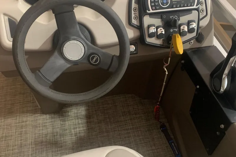 Slide: The Image of 2018 Princecraft Vectra 23 XT boat dashboard with steering wheel and control panel. - 7