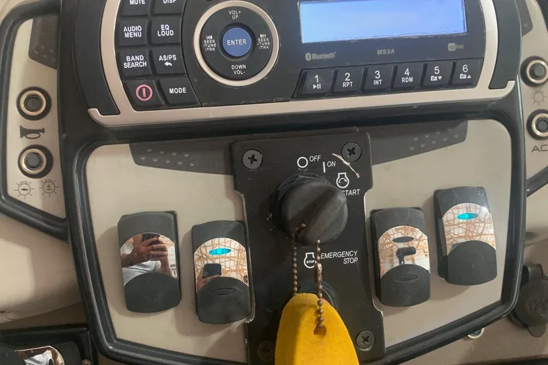 Slide: The Image of Control panel of a 2018 Princecraft Vectra 23 XT boat with various switches and buttons. - 8
