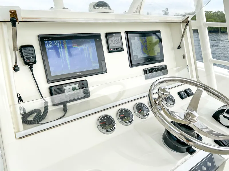 Slide: The Image of 2017 SeaVee 390z Center Console dashboard with navigation screens and steering wheel. - 14