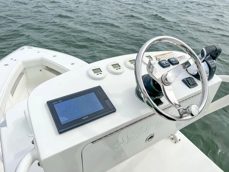 Slide: The Image of 2017 SeaVee 390z Center Console boat helm with steering wheel and navigation display. - 18